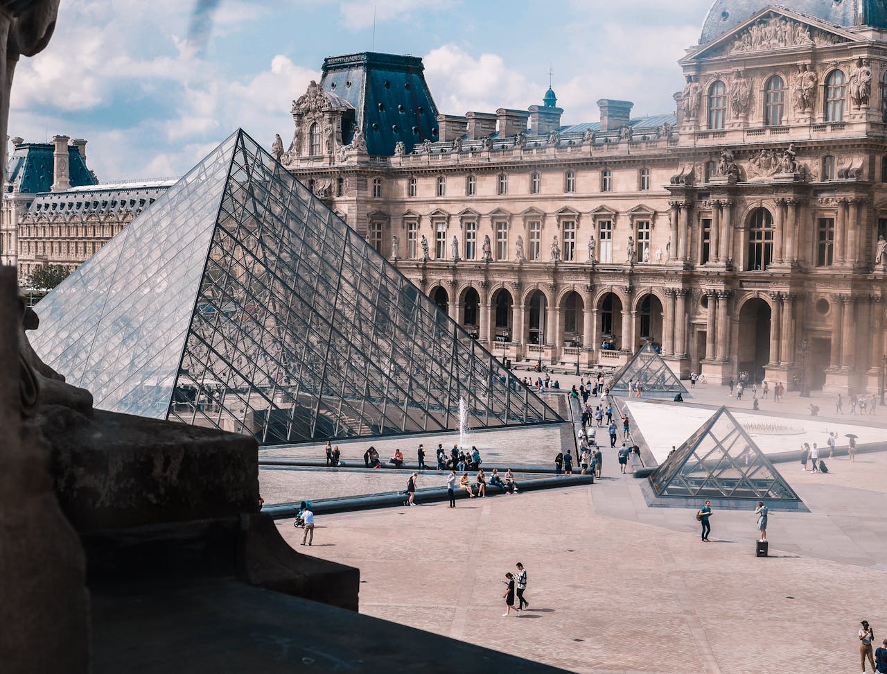 services-04 View of the Louvre Museum and iconic glass pyramid in Paris, a top tourist destination.